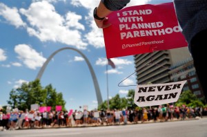 Abortion-rights supporters stand on both sides of a street near the Gateway Arch as they take part in a protest in favor of reproductive rights Thursday, May 30, 2019, in St. Louis. A St. Louis judge heard an hour of arguments Thursday on Planned Parentho