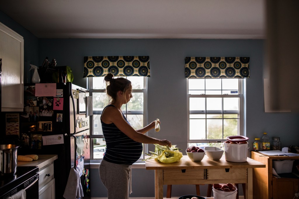 a pregnant woman in her kitchen