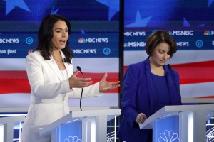 Democratic presidential candidate Rep. Tulsi Gabbard (D-HI) (L) speaks as Sen. Amy Klobuchar (D-MN) listens during the Democratic Presidential Debate at Tyler Perry Studios November 20, 2019 in Atlanta, Georgia.