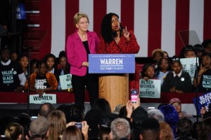 Democratic presidential candidate Sen. Elizabeth Warren (D-MA), stands with U.S. Rep. Ayanna Pressley (D-MA) as she addresses a group of protesters during a campaign event at Clark Atlanta University on November 21, 2019 in Atlanta, Georgia.