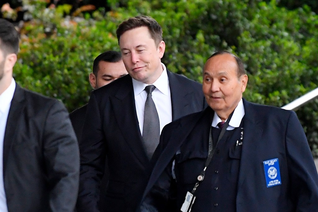 Tesla CEO Elon Musk, second from right, arrives at U.S. District Court Wednesday, Dec. 4, 2019, in Los Angeles.