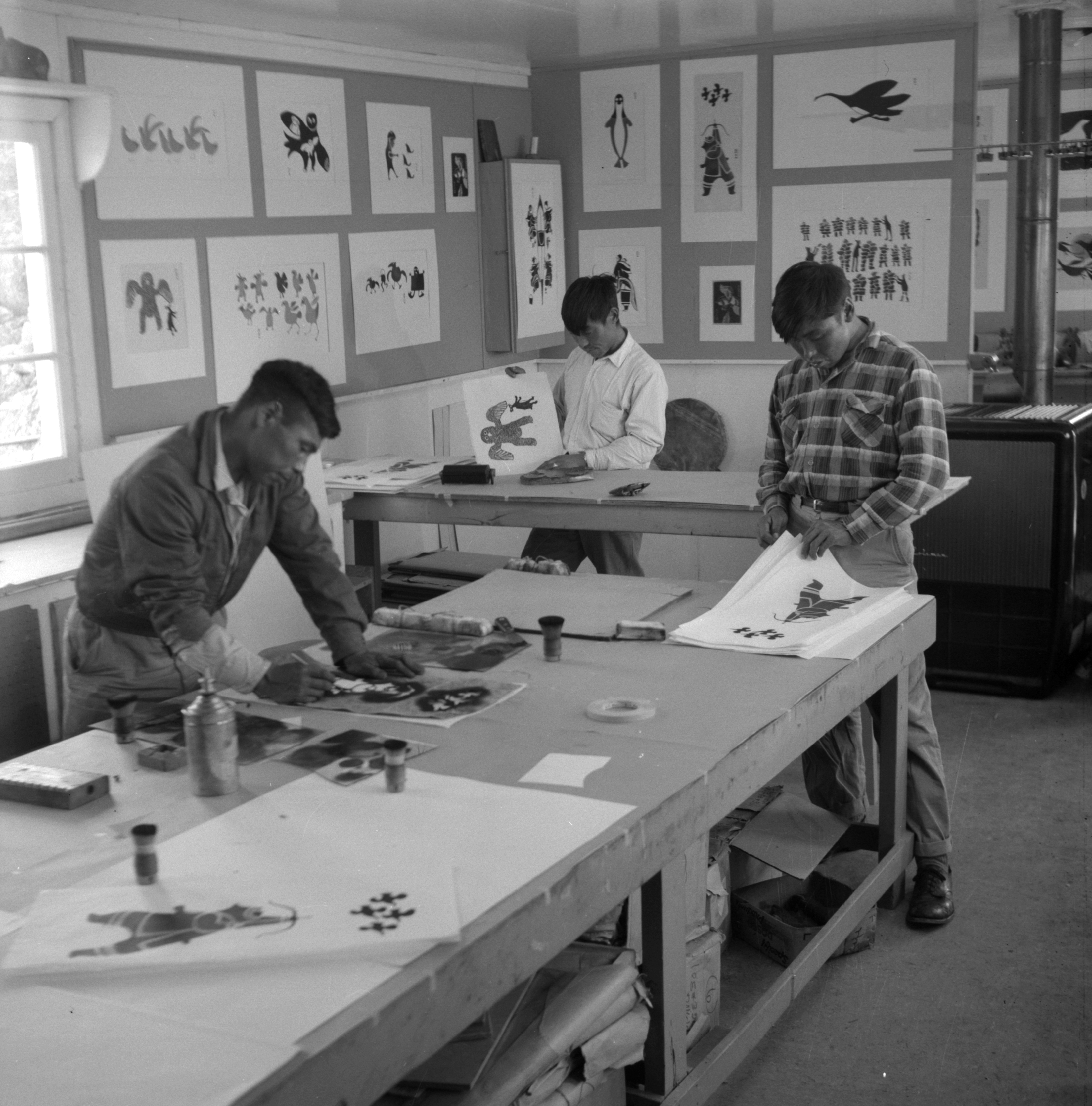 Artists (left to right) Iyola Kingwatsiak, Lukta Qiatsuq and Eegyvudluk Pootoogook (Inuit) inside the West Baffin Eskimo Co-operative, 1960. (Rosemary Eaton) © Libraries and Archives Canada