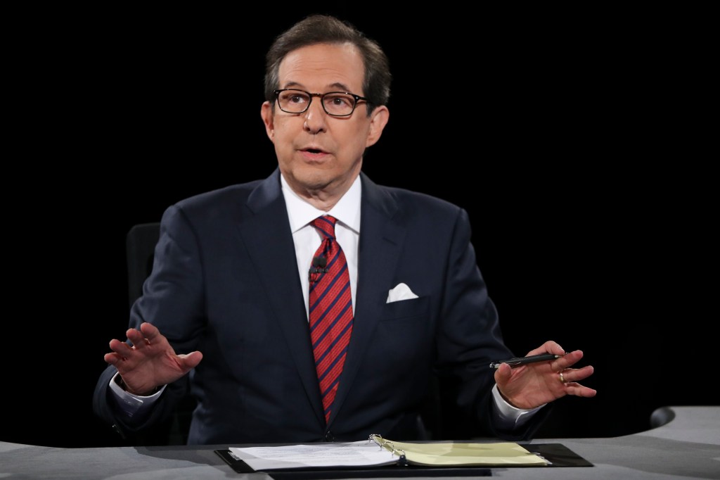 In this Oct. 19, 2016 file photo, moderator Chris Wallace guides the discussion between Democratic presidential nominee Hillary Clinton and Republican presidential nominee Donald Trump during the third presidential debate at UNLV in Las Vegas.