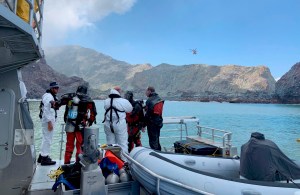 Police divers prepare to search the waters near White Island off the coast of Whakatane, New Zealand, Saturday Dec. 14, 2019.