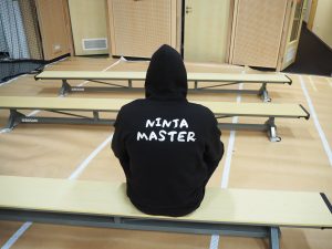 een man met een ninja-vest in een gymzaal