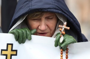 A woman participates in the National Rosary March in Warsaw, Poland, Saturday, Oct. 5, 2019, where people prayed and tried to appease God for what they called desecrations and insults of recent lesbian and gay pride parades.