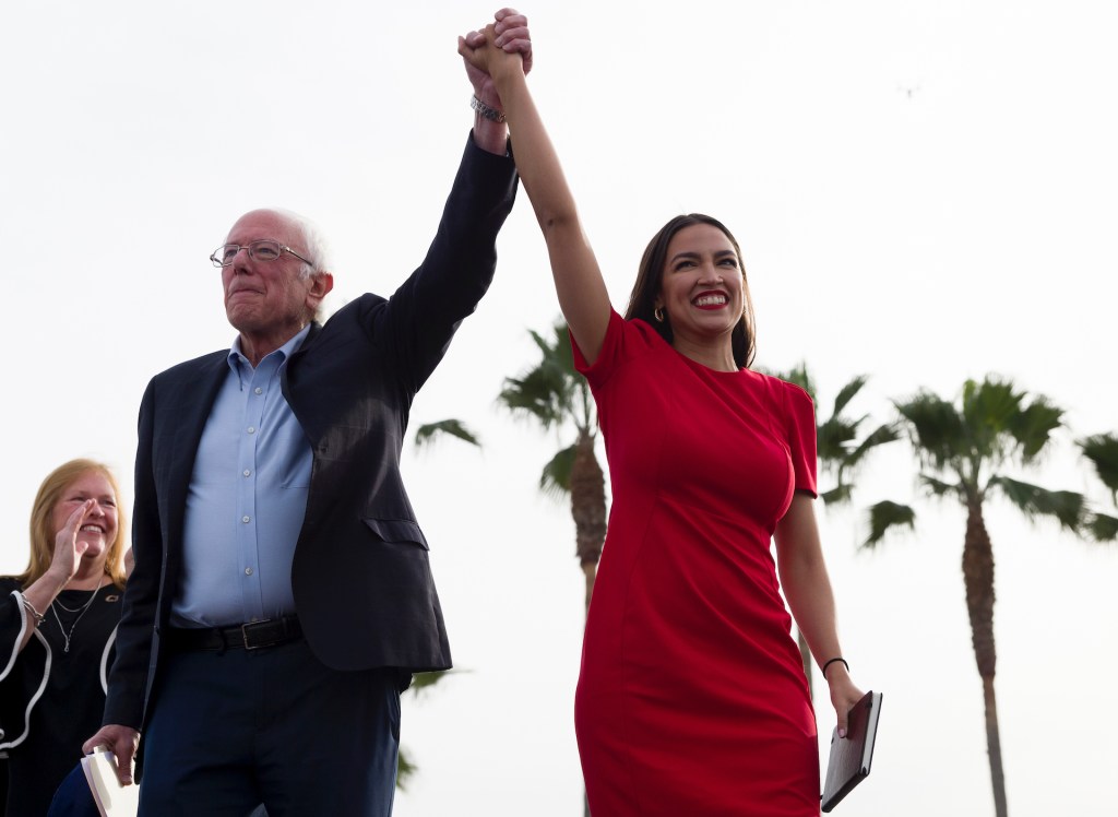 Democratic presidential candidate Sen. Bernie Sanders, I-Vt., and Rep. Alexandria Ocasio-Cortez, D-N.Y., greet the crowd during a rally in Venice, Calif., Saturday, Dec. 21, 2019.