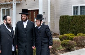 Community members stand in front of a rabbi's residence in Monsey, N.Y., Sunday, Dec. 29, 2019, following a stabbing Saturday night during a Hanukkah celebration. (AP Photo/Craig Ruttle)​