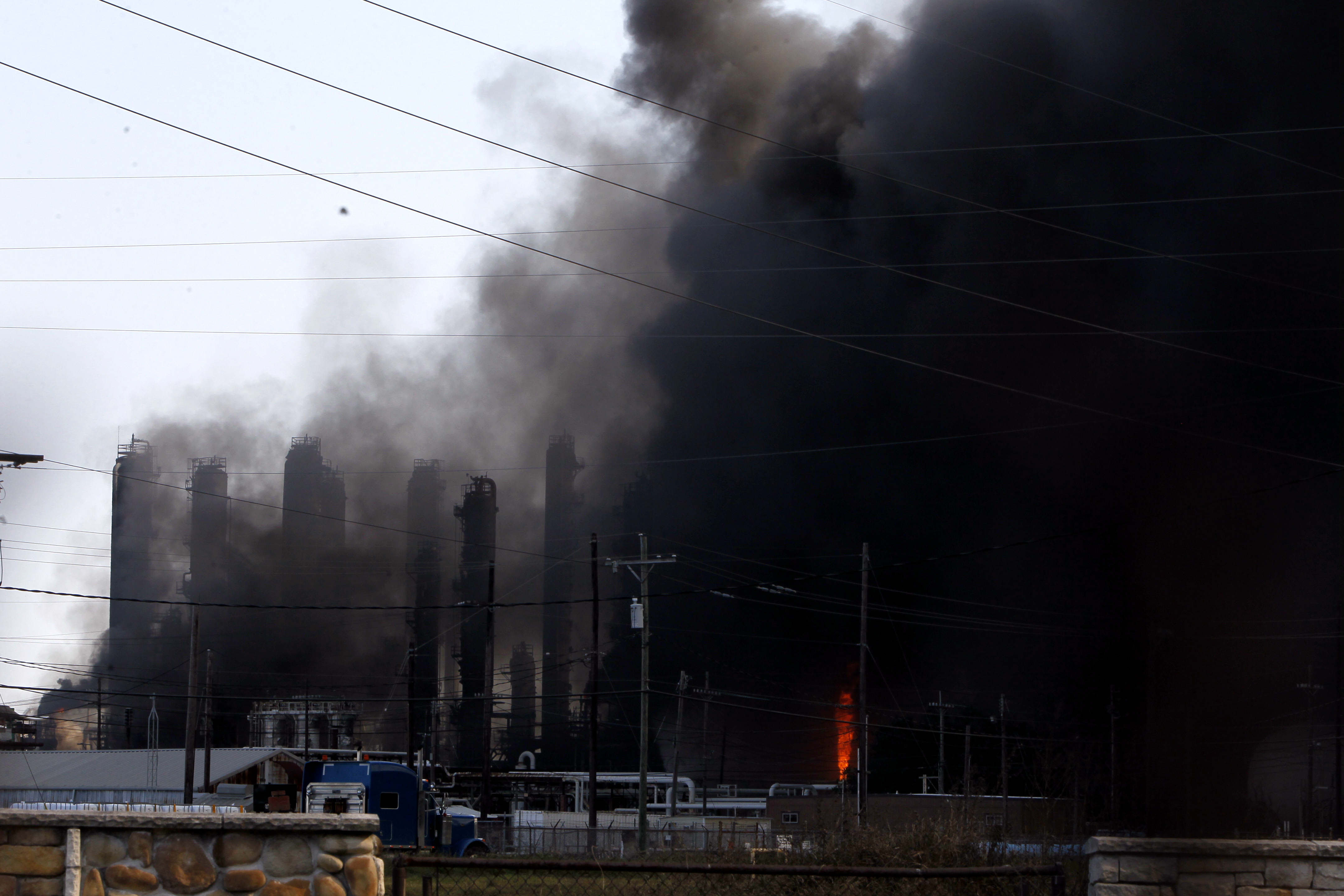 An oil plant surrounded by smoke.