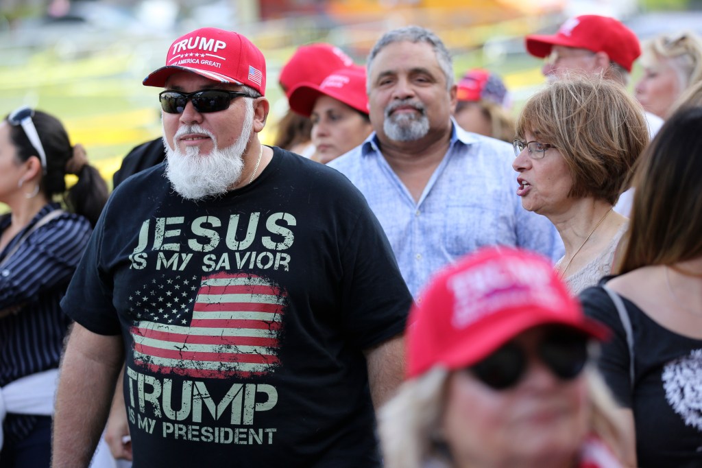 Jorge Alfonso, 56, of Miami, waits in line outside of the King Jesus International Ministry church where President Donald Trump is slated to hold a rally for evangelical supporters, Friday, Jan. 3, 2020, in Miami. Alfonso, originally from Cuba, has been a