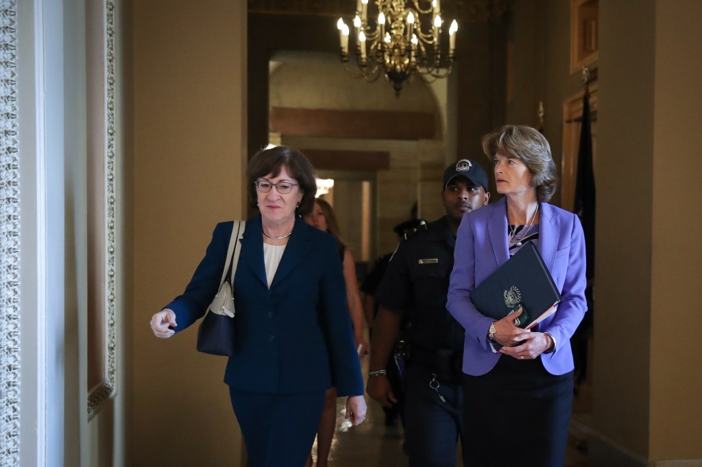 Sen. Susan Collins (R-ME) and Sen. Lisa Murkowski (R-AK) walk together as they arrive to a closed-door lunch meeting of GOP Senators at the U.S. Capitol, October 3, 2018 in Washington, DC.