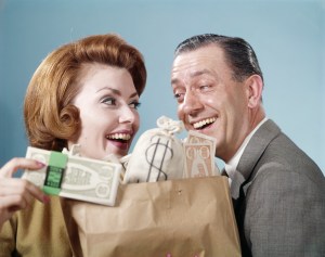 Old-style couple smile lovingly over a bag of money.