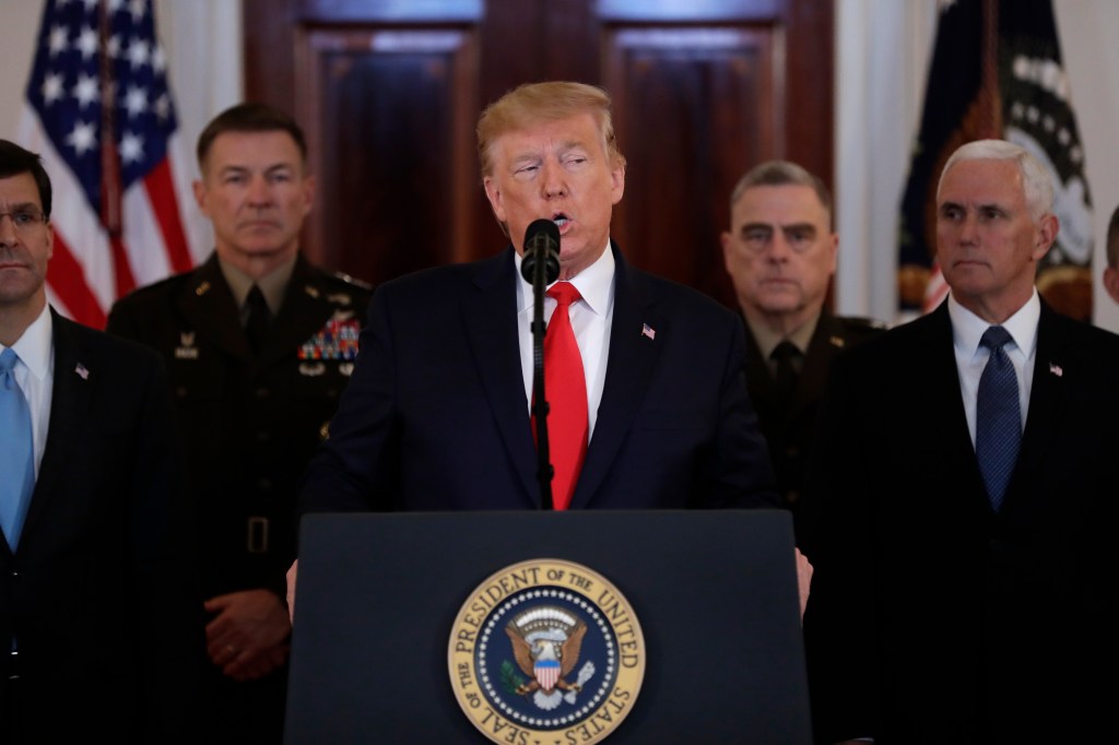 President Donald Trump addresses the nation from the White House on the ballistic missile strike that Iran launched against Iraqi air bases housing U.S. troops, Wednesday, Jan. 8, 2020, in Washington, as Vice President Mike Pence and others looks on. (AP