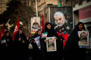 Mourners carry images of Iranian General Qassem Soleimani during the funeral ceremony in Tehran, Iran, on Monday, Jan. 6, 2020.​