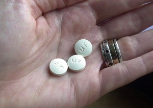 A photo of a hand holding abortion pills