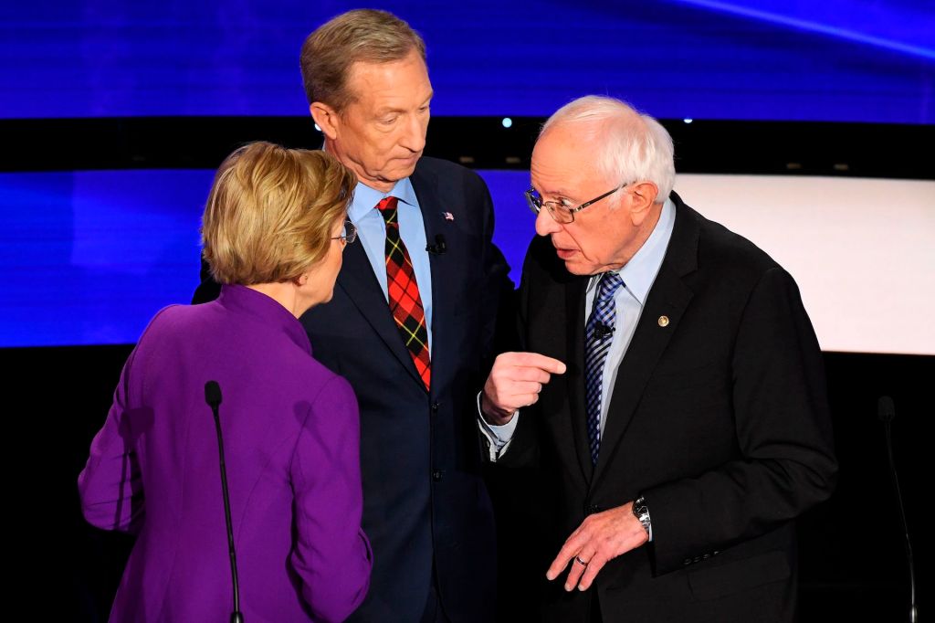 Democratic presidential hopeful Massachusetts Senator Elizabeth Warren (L) chats with Vermont Senator Bernie Sanders (L) alongside billionaire-philanthropist Tom Steyer (C) during a break of the seventh Democratic primary debate of the 2020 presidential c