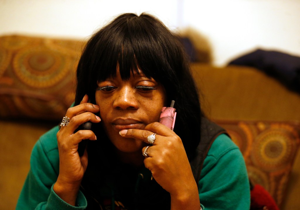 A black woman who belongs to Moms 4 Housing talks on the phone.