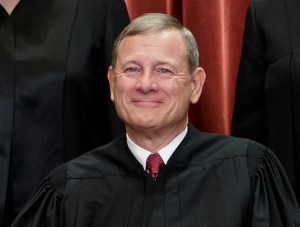 This Nov. 30, 2018, file photo shows Chief Justice of the United States, John G. Roberts, as he sits with fellow Supreme Court justices for a group portrait at the Supreme Court Building in Washington.