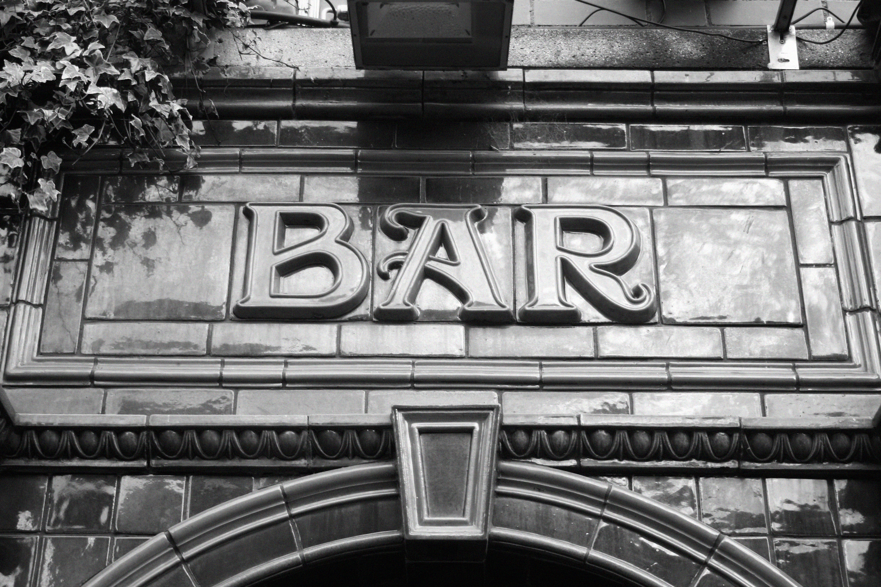 Black and white photo of stained glass bar awning