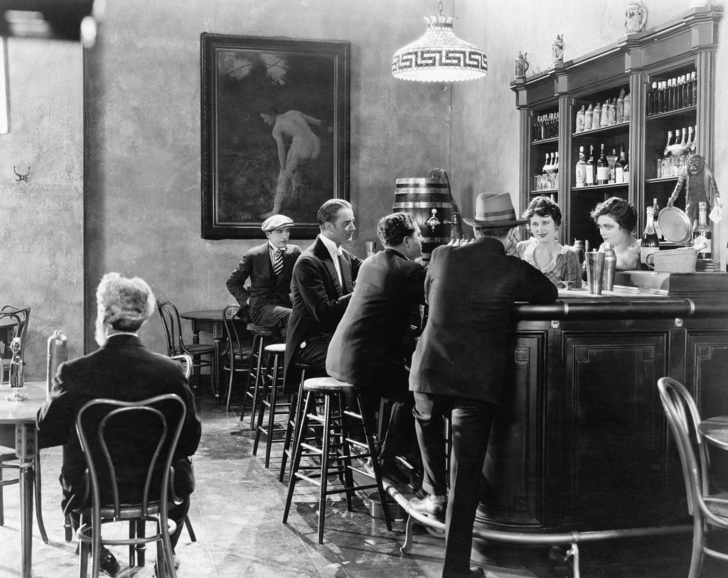 Black and white photo of men in Prohibition era speakeasy