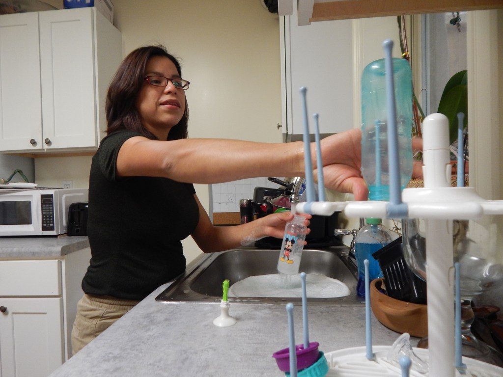 Argelia Morales Alvarez washing bottles.