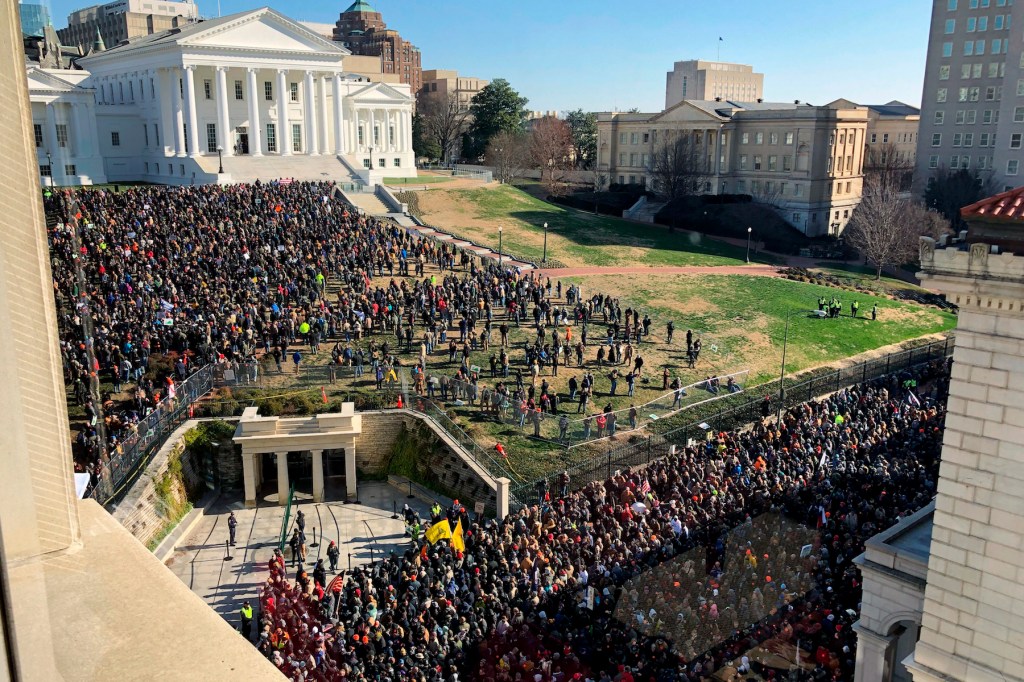 Demonstrators are seen during a pro-gun rally, Monday, Jan. 20, 2020, in Richmond, Va. Thousands of pro-gun supporters are expected at the rally to oppose gun control legislation like universal background checks that are being pushed by the newly elected