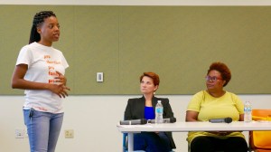 Dr. Colleen McNicholas and Pamela Merritt listen to Evonnia Woods, the panel's moderator, introduce the forum on self-managed abortion.