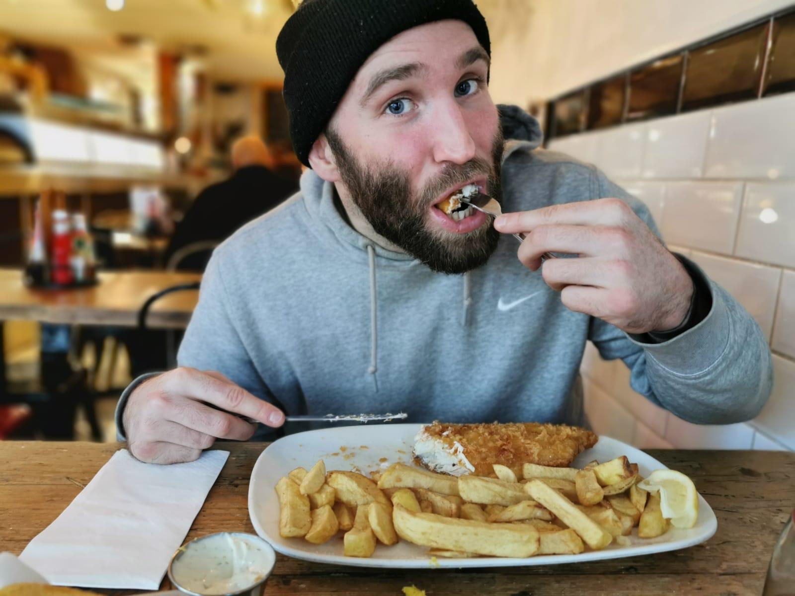 man eating fish and chips