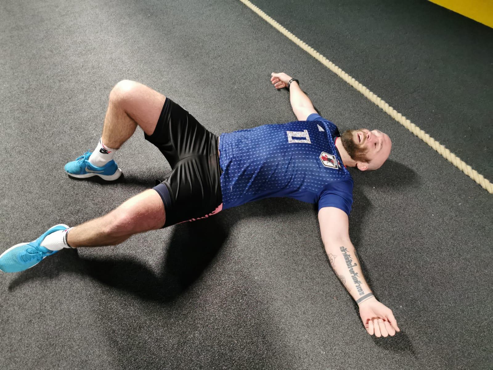 man exhausted on floor