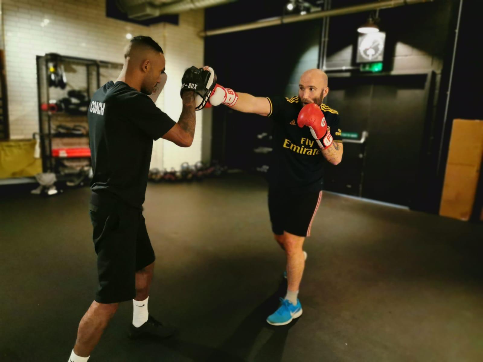 two men boxing pads