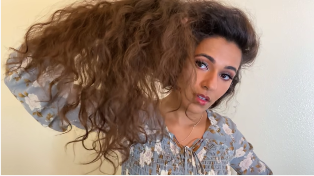 Ayesha Malik displays what she says is damage to her hair caused by DevaCurl