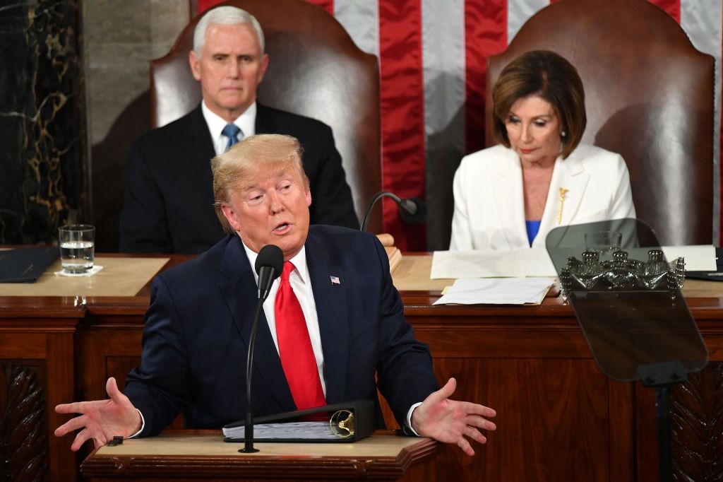 President Donald Trump delivers the State of the Union address flanked by US Vice President Mike Pence and Speaker of the US House of Representatives Nancy Pelosi (R) at the US Capitol in Washington, DC, on February 4, 2020.