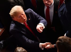 Donald Trump pointing to someone in a crowd.