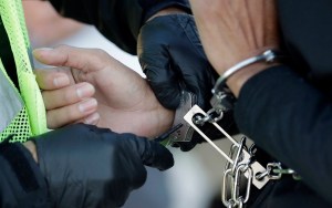 In this Nov. 16, 2018, file photo, an immigrant who entered the United States illegally is checked before boarding a deportation flight to El Salvador by U.S. Immigration and Customs Enforcement in Houston. (AP Photo/David J. Phillip, File)​