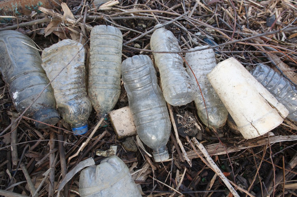 Plastic bottles and other refuse lay washed up on the banks of a tidal inlet off the Delaware River at Pennypack On The Delaware Park in Philadelphia, PA, February 8, 2020. This plastic pollution covers the shoreline where Pennypack Creek empties into the