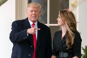 In this March 29, 2018 file photo, President Donald Trump points to outgoing White House Communications Director Hope Hicks on her last day before he boards Marine One on the South Lawn of the White House in Washington.