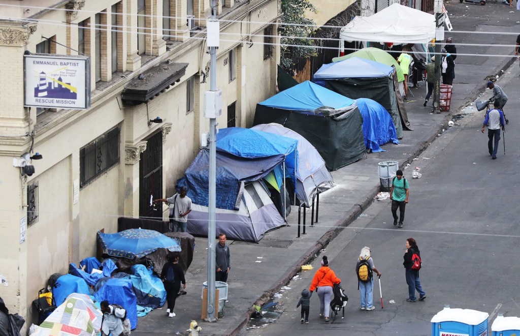 People walk in Skid Row on September 28, 2019 in Los Angeles, California.