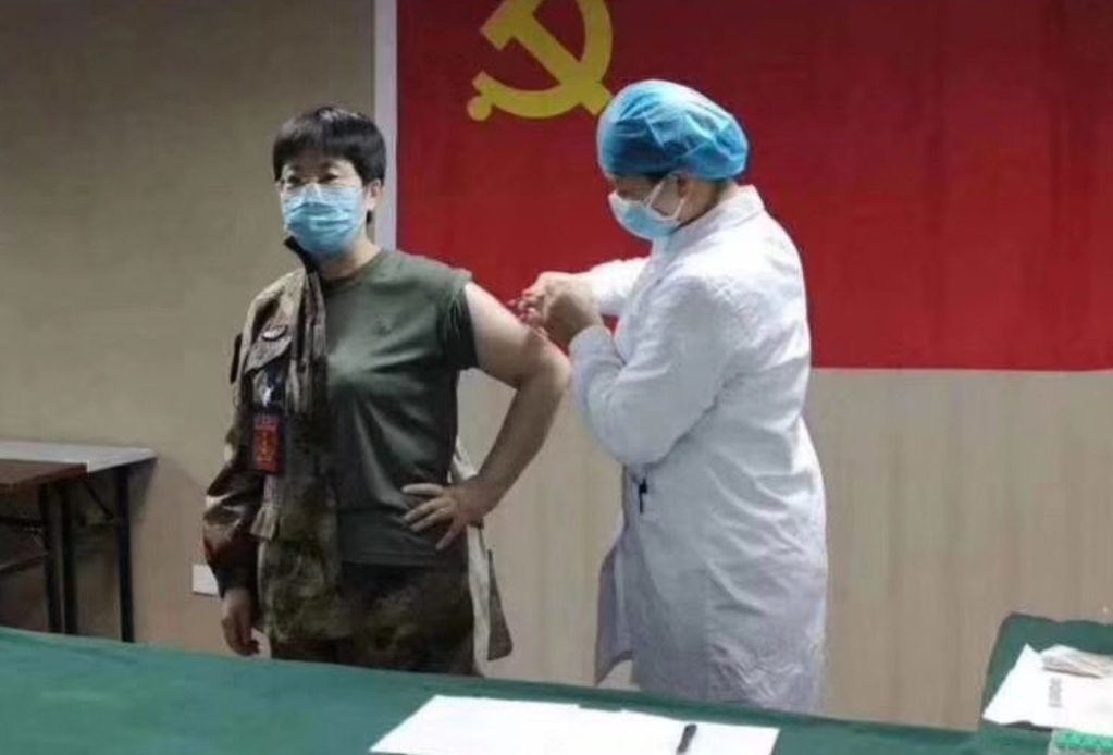 An image posted by the official Weibo account of the People’s Liberation Army showing Chen Wei being injected at the Wuhan laboratory she has been working in since mid-January.