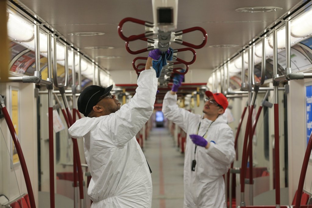 TTC employees wiping down transit vehicle