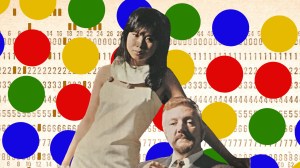 The original models for the Mastermind board game in their iconic pose in front of a field of colored dots and a backdrop of computer punchcards.