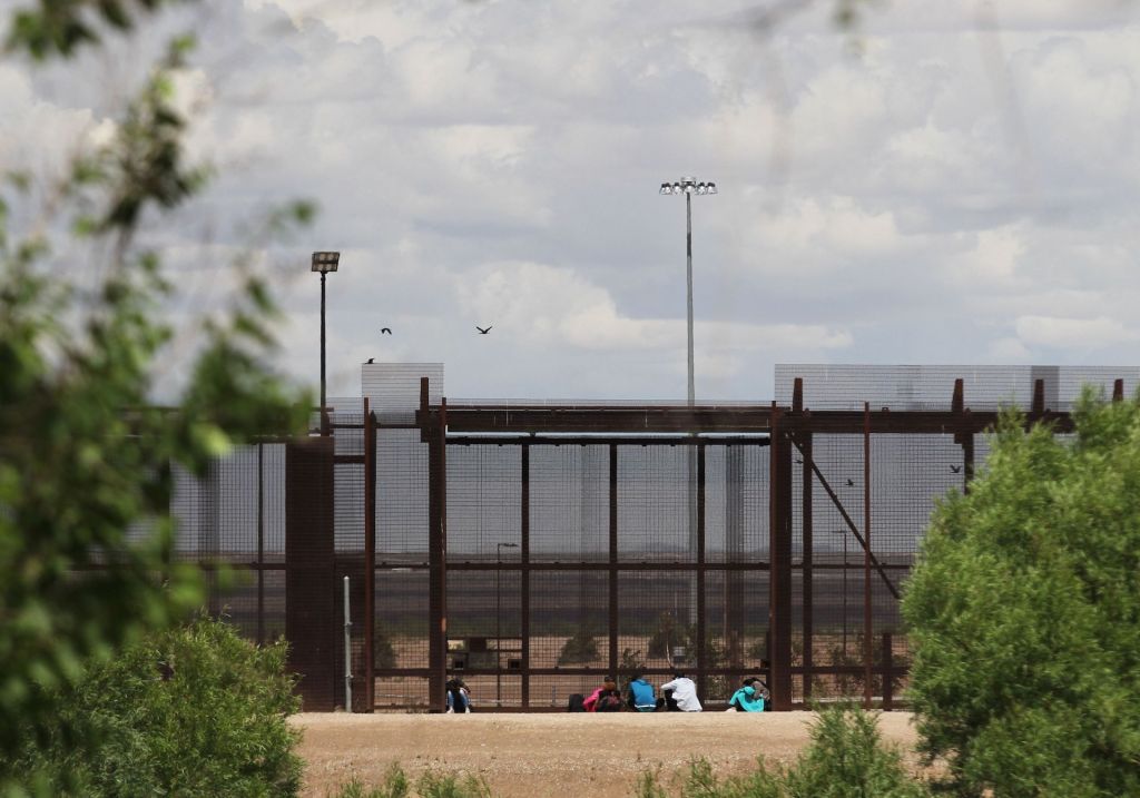 A group of migrants wait to be stopped by the Border Patrol in the border wall in El Paso, Texas as seen from Ciudad Juarez, State of Chihuahua, Mexico on April 24, 2019.