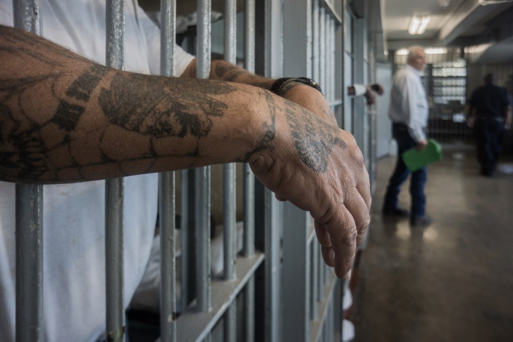 An incarcerated person's hands in a jail cell at Angola, 2013.​