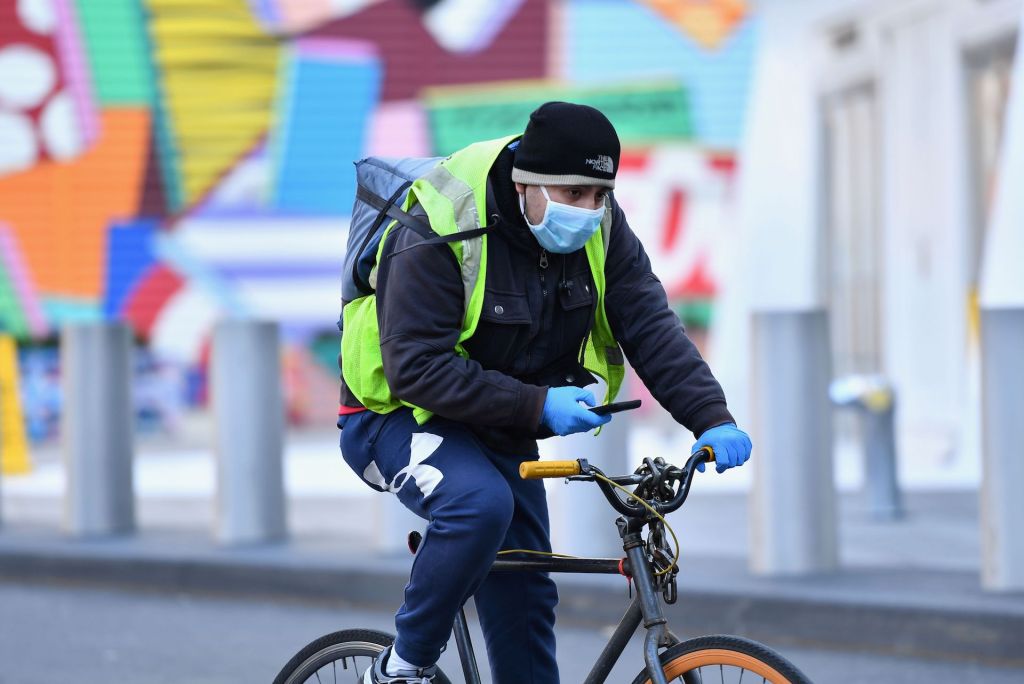 A food delivery person is seen on a bike on March 18, 2020 in New York City.