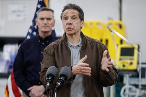 New York Gov. Andrew Cuomo speaks during a news conference alongside the National Guard at the Jacob Javits Center that will house a temporary hospital in response to the COVID-19 outbreak, Monday, March 23, 2020, in New York. (AP Photo/John Minchillo)​