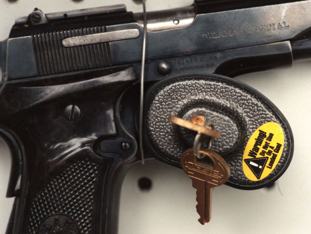 A photo of a handgun and a trigger lock.