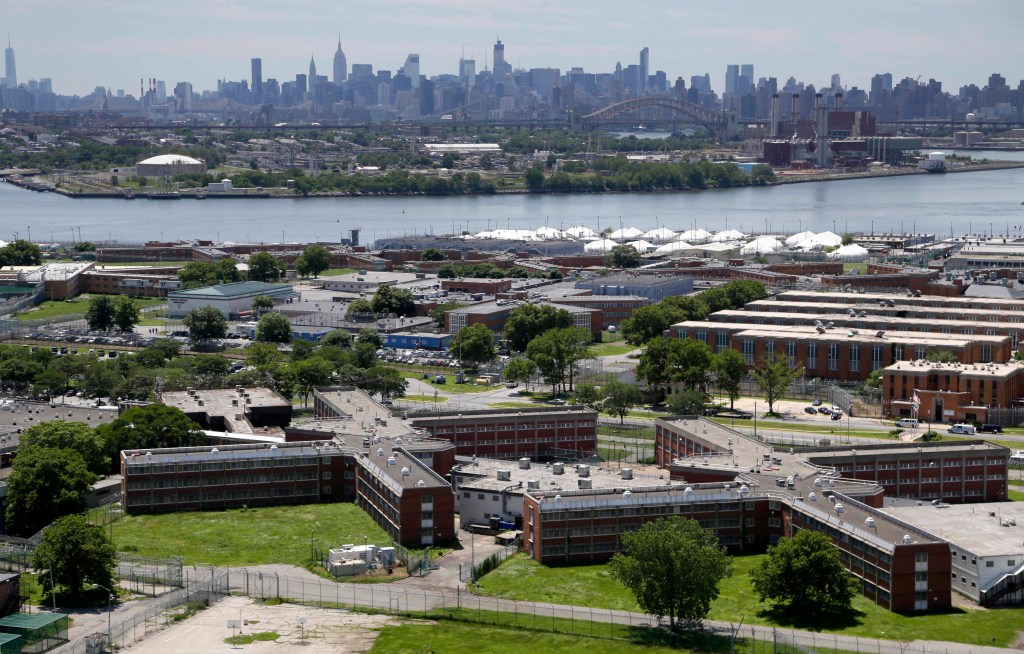 This June 20, 2014 file photo shows the Rikers Island jail complex in New York with the Manhattan skyline in the background.