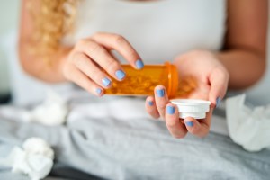 woman taking medication GettyImages