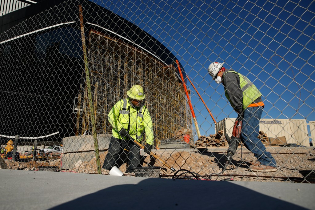 Cover: Workers dig as construction continues at a site in Las Vegas, during the coronavirus pandemic Tuesday, March 31, 2020, in Las Vegas. (AP Photo/John Locher)​