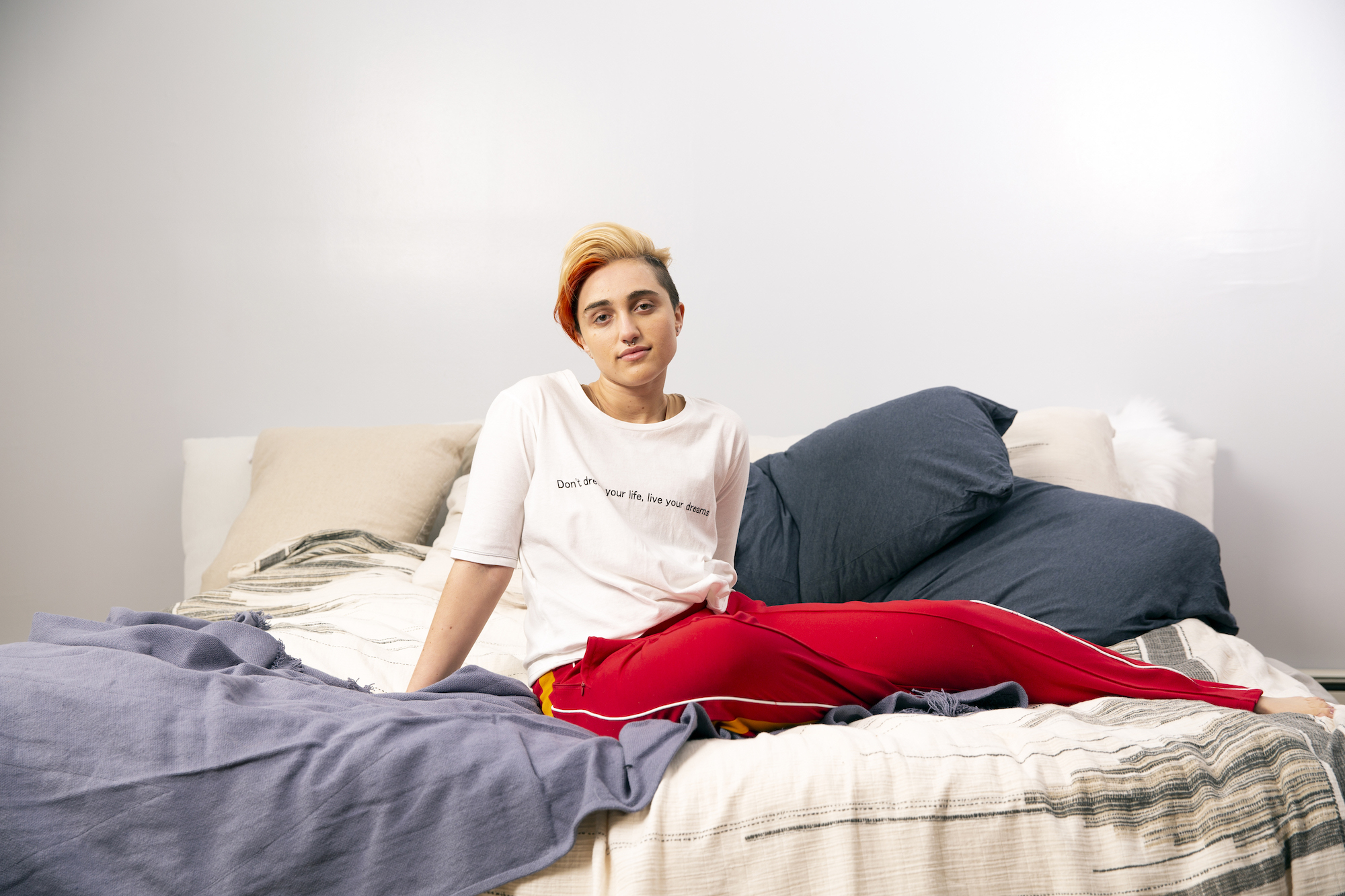 1585568469625-A-transmasculine-gender-nonconforming-person-sitting-on-a-bed