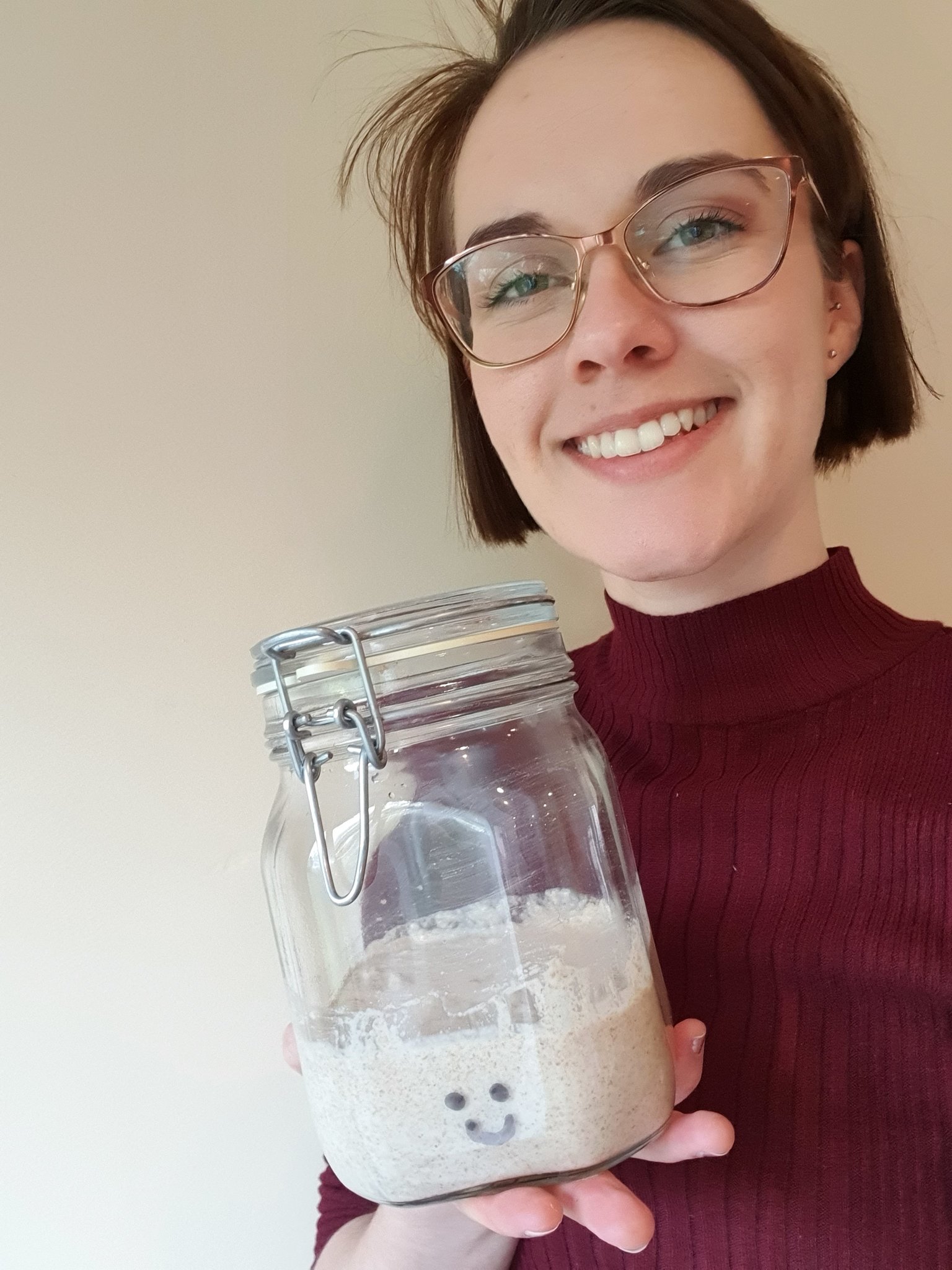 A woman holding her pet sourdough starter